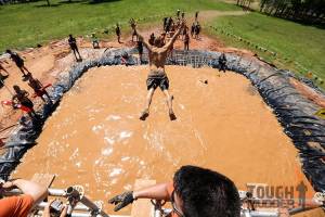 tough-mudder_walk-the-plank_water-jump_swimming-laps_arms-outstretched-overhead